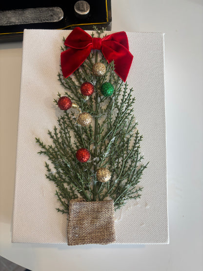 Decorative Christmas card with greenery, red bow, and gold ornaments on a white background.